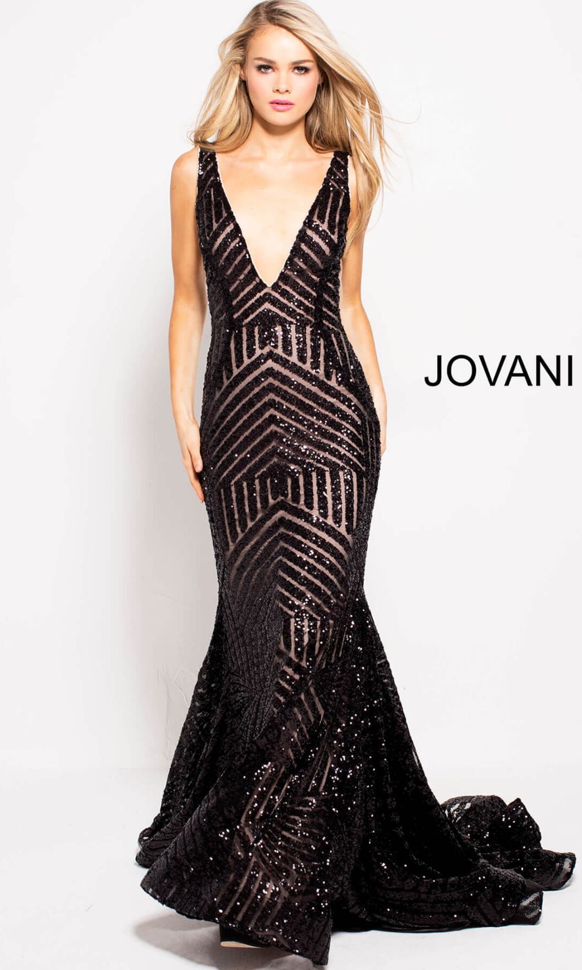 A woman stands against a plain white background wearing a Jovani Prom Dress with striped sequin pattern in black/nude. The gown is sleeveless, floor-length, and v-neck, with the